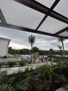 a view from the lobby of a resort with palm trees at Ecoresort Quinta de Sta Bárbara in Pirenópolis
