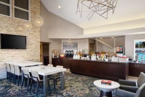 a restaurant with tables and chairs and a counter at Residence Inn Cherry Hill Philadelphia in Cherry Hill