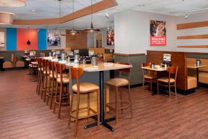 a dining room with a long table and chairs at Fairfield Inn & Suites by Marriott Alexandria West/Mark Center in Alexandria