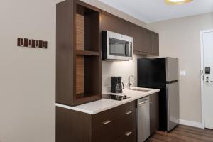 a kitchen with a sink and a refrigerator at TownePlace Suites by Marriott Titusville Kennedy Space Center in Titusville