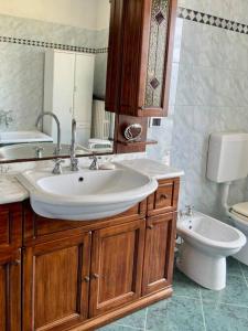 ein Bad mit einem Waschbecken und einem WC in der Unterkunft Spicchio di Langa - casa indipendente tra le vigne e le Alpi in Belvedere Langhe