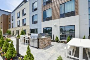 a patio with a grill in front of a building at TownePlace Suites by Marriott Cranbury South Brunswick in Cranbury