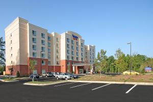 a large building with cars parked in a parking lot at Fairfield Inn & Suites Raleigh-Durham Airport/Brier Creek in Durham