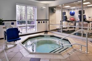 a jacuzzi tub in a room with a chair at Fairfield Inn & Suites Raleigh-Durham Airport/Brier Creek in Durham
