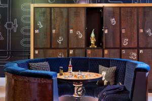 a blue couch with a table on top of it at Moxy Warsaw Praga in Warsaw