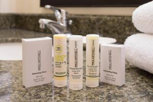 four tubes of sunscreen sitting on a bathroom counter at Fairfield Inn & Suites by Marriott Portland North in Portland