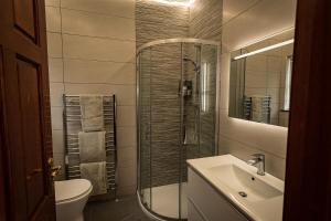 a bathroom with a shower and a sink and a toilet at Glendaloch B&B in Antrim +62 photos