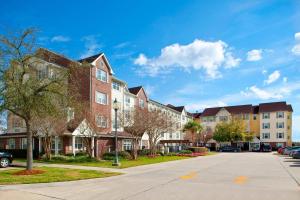 a row of apartment buildings in a residential neighborhood at TownePlace Suites New Orleans Metairie in Harahan