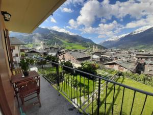 a balcony with a view of a town and mountains at THE YELLOW HOUSE in Bormio
