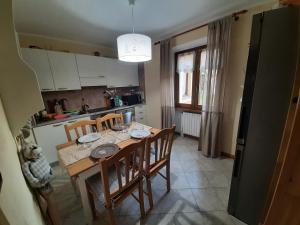 a kitchen with a table and chairs and a dining room at THE YELLOW HOUSE in Bormio