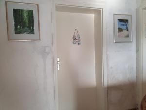 a door in a room with two pictures on the wall at 1-Zimmer-Apartment "Meeresrauschen" in Peenemünde in Peenemünde