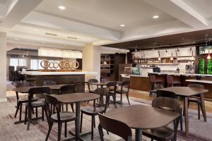 a restaurant with tables and chairs and a bar at Courtyard by Marriott San Jose South/Morgan Hill in Morgan Hill