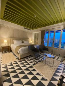 a bedroom with a bed and a checkerboard floor at La Menara Hotel & SPA in Sidi Bou Saïd