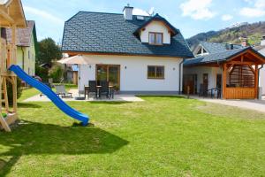 un parque infantil con un tobogán azul en un patio en Chalet Mama, en Pruggern