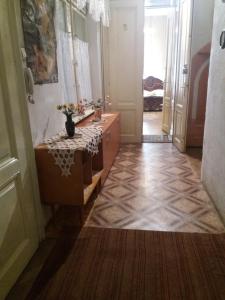 a bathroom with a sink and a table in a room at Garsoniera Alegna in Sibiu