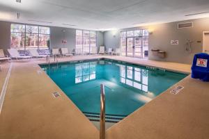 a large swimming pool with blue water in a building at Four Points by Sheraton Raleigh Durham Airport in Morrisville