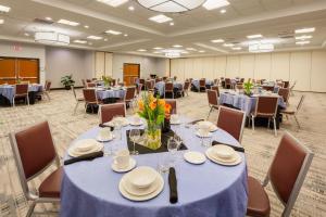 a large room with tables and chairs with blue table cloth at Four Points by Sheraton Raleigh Durham Airport in Morrisville