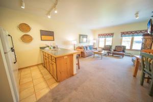 a kitchen and living room with a sink and a refrigerator at Jack Pine 8015 in Keystone