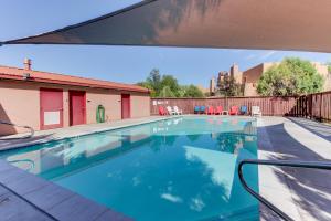 a swimming pool with chairs and a fence at Solano Vallejo 3343 in Moab
