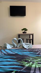 a bedroom with a bed with two swans on it at Studio de Célestine in Vernon +9 photos
