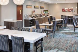 a restaurant with tables and chairs and a counter at Residence Inn Minneapolis Downtown/City Center in Minneapolis