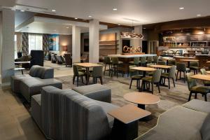 a restaurant with tables and chairs and a bar at Courtyard by Marriott Maui Kahului Airport in Kahului