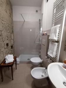 a bathroom with a sink and a toilet and a shower at APPARTAMENTO CISTERNA 33 in San Gimignano