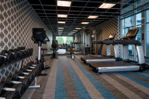 a gym with treadmills and machines in a room at Aloft Hotel Rogers Bentonville in Rogers