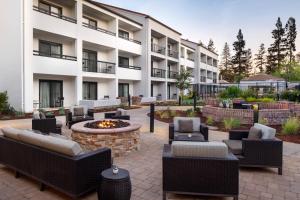 a courtyard with chairs and a fire pit in front of a building at Courtyard San Jose Cupertino in Cupertino
