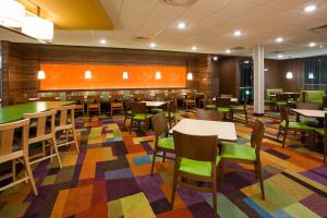 a dining room with tables and chairs on a colorful rug at Fairfield Inn & Suites by Marriott St. Paul Northeast in Vadnais Heights