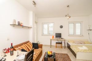 a living room with a couch and a table at Dubrovnik Summer Apartments in Dubrovnik