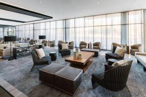 a lobby with couches and chairs and a table at AC Hotel by Marriott Scottsdale North in Scottsdale