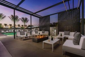 a patio with white furniture and a fire pit at AC Hotel by Marriott Scottsdale North in Scottsdale