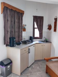 a small kitchen with a counter and a window at Blue Sea Studios in Arkasa +23 photos