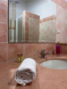 a bathroom with a sink with a towel on it at ASSUMBRA Casa Vacanze in Santa Maria Navarrese
