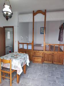 a bedroom with a four poster bed and a table at Blue Sea Studios in Arkasa