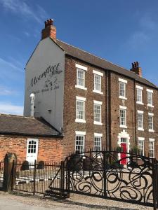 a large brick building with a sign on it at Moonfleet Guest House in Skinningrove