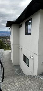 a white building with windows on the side of it at Shannon Heights B&B in West Kelowna