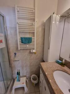 a bathroom with a tub and a sink and a shower at Porquerolles - La Porquerollaise in Porquerolles