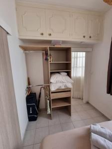 a small bedroom with a bed in a room at Porquerolles - La Porquerollaise in Porquerolles