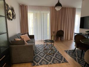 a living room with a couch and a table at APARTAMENT VELVET in Świnoujście