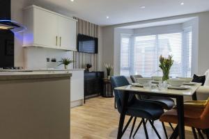 a kitchen and dining room with a table and chairs at The Belfast Collection - BT7 in Belfast