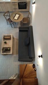 a living room with a table and a couch and a table and chairs at Blue house II in Palekastron