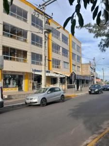 a silver car parked in front of a building at Lebanon Praia Hotel in Tramandaí