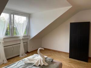 a swan sitting on a bed in a bedroom at Charmante Zentrale WG in Wesseling in Wesseling
