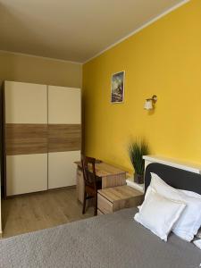 a bedroom with a bed and a desk and a table at Valentino´s Residence in Constanţa