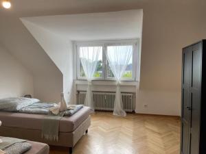 a bedroom with two beds and a large window at Comfortable Shared Apartment with Private Room in Wesseling in Wesseling