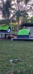 two tents are set up in a field at Tranquille Campsite in San Isidro
