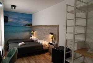 Postel nebo postele na pokoji v ubytování Hotel Ridomar 365