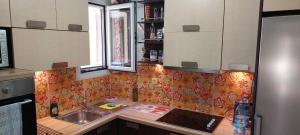 A kitchen or kitchenette at Flora's Boutique Apartment at the heart of Corfu